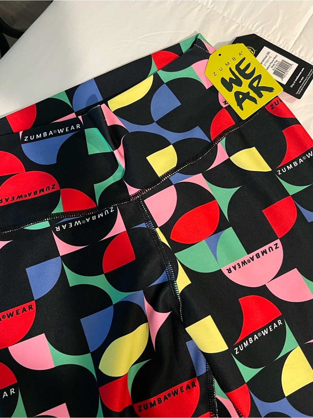 Zumba Fitness Kids Black Leggings with Red, Yellow, Blue, Green & Pink Geo Print - Picture 2 of 3